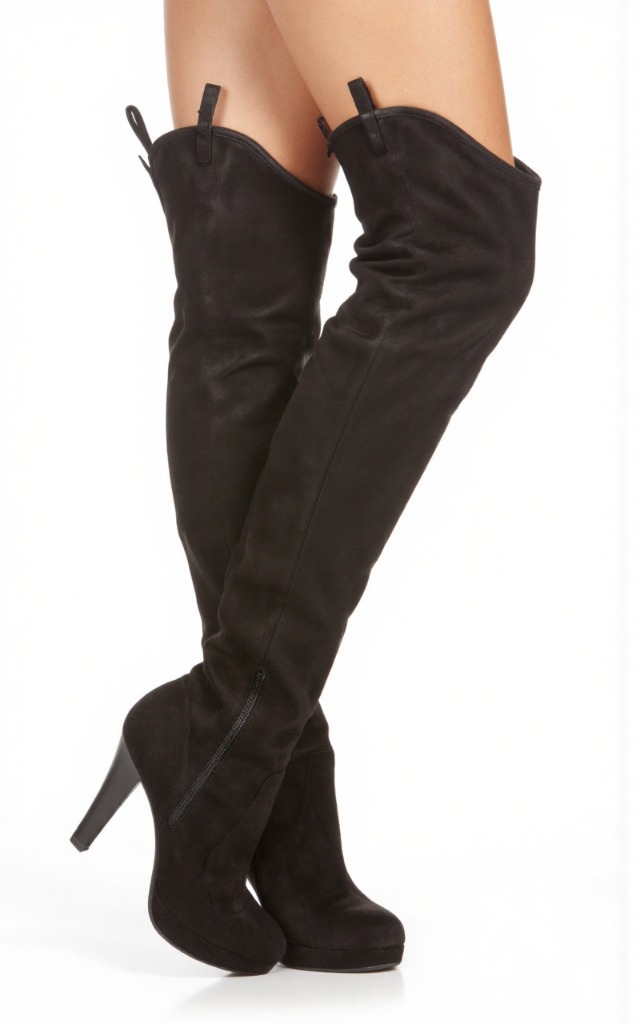 A female model wearing over   the   knee boots, against a white background, with a close   up of the feet